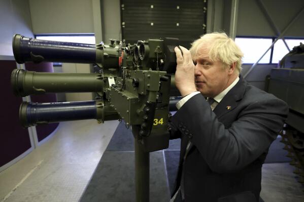 Britain's Prime Minister Boris Johnson with a Mark 3 shoulder launch LML (Lightweight Multiple Launcher) missile system, at Thales weapons manufacturer in Belfast, Monday May 16, 2022, during a visit to Northern Ireland. Johnson said there would be “a necessity to act” if the EU doesn't agree to overhaul post-Brexit trade rules that he says are destabilizing Northern Ireland's delicate political balance. Johnson held private talks with the leaders of Northern Ireland's main political parties, urging them to get back to work. (Liam McBurney/Pool via AP)