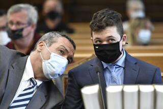FILE - In this May 21, 2021 file photo, Kyle Rittenhouse, right, listens to his attorney, Mark Richards, during Rittenhouse's pretrial hearing at the Kenosha County Courthouse in Kenosha, Wis. The family of one of the two men fatally shot during a demonstration against police violence in Kenosha has filed a federal civil lawsuit against local law enforcement accusing officers of facilitating Kyle Rittenhouse's attacks. (Sean Krajacic/The Kenosha News via AP, Pool File)