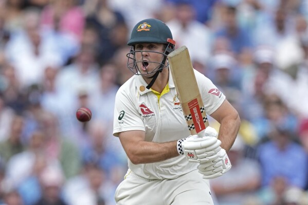 Australia's Mitchell Marsh reacts after playing a shot during the second day of the fifth Ashes Test match between England and Australia at The Oval cricket ground in London, Friday, July 28, 2023. (AP Photo/Kirsty Wigglesworth)
