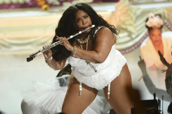 FILE - This June 23, 2019 file photo shows Lizzo playing the flute at the BET Awards in Los Angeles. Billie Eilish and Lizzo, are both nominated for the top four prizes at the Grammy Awards. They will perform at the Grammy Awards on Jan. 26. (Photo by Chris Pizzello/Invision/AP, File)