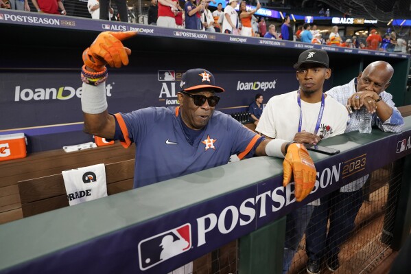 Houston Astros manager Dusty Baker Jr., left, talks with reporters during batting practice before Game 4 of the baseball American League Championship against the Texas Rangers Series Thursday, Oct. 19, 2023, in Arlington, Texas. (AP Photo/Tony Gutierrez)