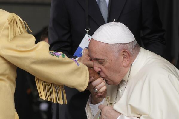 Pope Francis kisses hand to Canadian Indigenous woman as he arrives at Edmonton's International airport, Canada, Sunday, July 24, 2022. Pope Francis begins a weeklong trip to Canada on Sunday to apologize to Indigenous peoples for the abuses committed by Catholic missionaries in the country's notorious residential schools. (AP Photo/Gregorio Borgia)