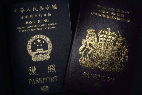 A British National Overseas passports (BNO) and a Hong Kong Special Administrative Region of the People's Republic of China passport are pictured in Hong Kong, Friday, Jan. 29, 2021. China said Friday it will no longer recognize the British National Overseas passport as a valid travel document or form of identification amid a bitter feud with London over a plan to allow millions of Hong Kong residents a route to residency and eventual citizenship. (AP Photo/Kin Cheung)