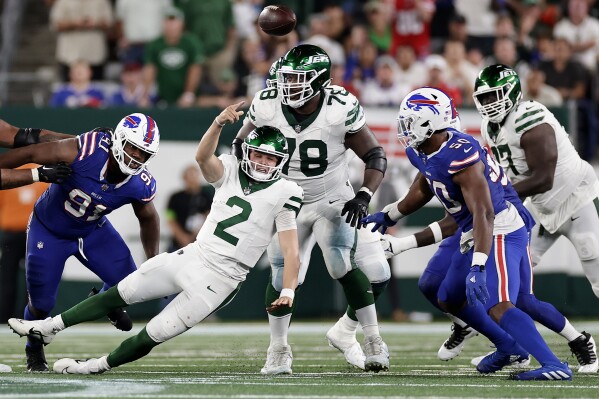New York Jets quarterback Zach Wilson (2) passes against the Buffalo Bills as he falls to the ground during the fourth quarter of an NFL football game, Monday, Sept. 11, 2023, in East Rutherford, N.J. (AP Photo/Adam Hunger)