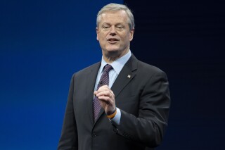 FILE - Incoming NCAA president Charlie Baker speaks during the NCAA Convention, Thursday, Jan. 12, 2023, in San Antonio. Baker wants to create a new tier of Division I where athlete can be paid by schools. The new subdivision for schools with the most athletic resources could offer unlimited educational benefits, enter into name, image and likeness partnerships with athletes and compensate them through a trust fund (APPhoto/Darren Abate, File)