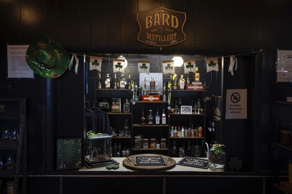 Bottles and decorations are seen in the tasting area of The Bard Distillery in Graham, Ky., Sunday, March 9, 2025. (AP Photo/Jon Cherry)