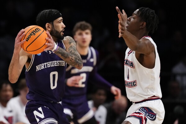 Florida Atlantic's Johnell Davis, right, defends Northwestern's Boo Buie (0) during the first half of a first-round college basketball game in the NCAA Tournament, Friday, March 22, 2024, in New York. (AP Photo/Frank Franklin II)