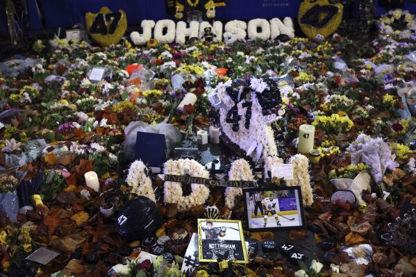 A general view of tributes to Nottingham Panthers' Adam Johnson ahead of the Adam Johnson Memorial Game at the Motorpoint Arena, in Nottingham, England, Saturday, Nov. 18, 2023 Johnson, a 29-year-old from Minnesota, died at a hospital after being cut in the neck by the skate blade of an opponent during a game on Oct. 28. (Bradley Collyer/PA via AP)