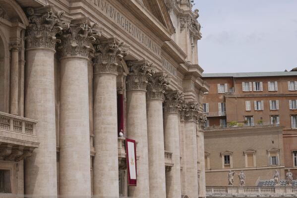 Pope Leo XIV appears at the central balcony of St. Peter's Basilica for his first Sunday blessing after his election, in St. Peter's Square at the Vatican, Sunday May 11, 2025. (AP Photo/Domenico Stinellis)