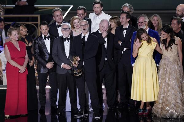 Jesse Armstrong, center, and the cast and crew of "Succession" accept the Emmy for outstanding drama at the 74th Primetime Emmy Awards on Monday, Sept. 12, 2022, at the Microsoft Theater in Los Angeles. (AP Photo/Mark Terrill)