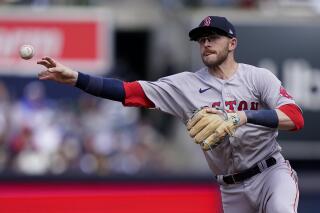 Boston Red Sox second baseman Trevor Story (10) throws to first to put out New York Yankees' Josh Donaldson in the first inning of an opening day baseball game, Friday, April 8, 2022, in New York. (AP Photo/John Minchillo)