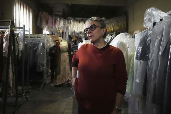 Anna Biagiotti, head of tailoring at the Rome's Teatro dell' Opera" opera house, walks in the house's costumes warehouse, Thursday, April 10, 2025. (AP Photo/Andrew Medichini)