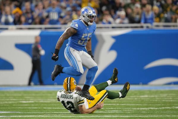Green Bay Packers quarterback Aaron Rodgers (12) is sacked by Detroit Lions linebacker Derrick Barnes (55)during the first half of an NFL football game, Sunday, Nov. 6, 2022, in Detroit. (AP Photo/Paul Sancya)