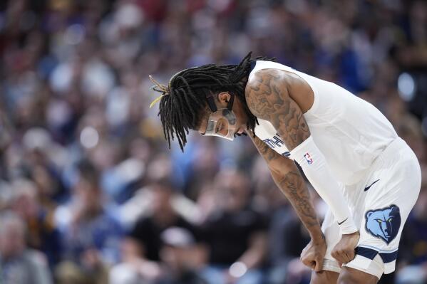 Memphis Grizzlies guard Ja Morant reacts as the team trails the Denver Nuggets during the second half of an NBA basketball game Friday, March 3, 2023, in Denver. (AP Photo/David Zalubowski)