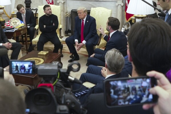 Vice President JD Vance, right, speaks with Ukrainian President Volodymyr Zelenskyy, left, as President Donald Trump, center, listens in the Oval Office at the White House, Friday, Feb. 28, 2025, in Washington. (AP Photo/ Mystyslav Chernov)