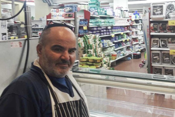 This 2021 photo provided by Haim Parag shows David Ben-Avraham at a supermarket in the Israeli town of Beit Shemesh, where he briefly worked. Ben-Avraham, a Palestinian who was born a Muslim but made the almost unheard-of decision to convert to Judaism years earlier, was fatally shot by an Israeli soldier. (Courtesy of Haim Parag via AP)
