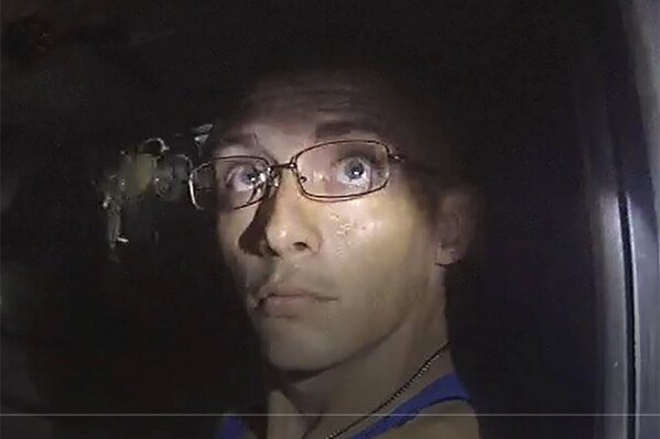 In this image, released by the Georgia Bureau of Investigation, taken from a deputy’s body camera, Texas fugitive Dalton Potter is questioned during a traffic stop on Monday, Sept. 7, 2020, in Dalton, Ga. A GBI statement released Tuesday, Sept. 8, said one of two Texas fugitives wanted after a Georgia deputy was shot during the traffic stop, Jonathan Hosmer, has been apprehended, while Potter remains at large.  (Georgia Bureau of Investigation via AP)