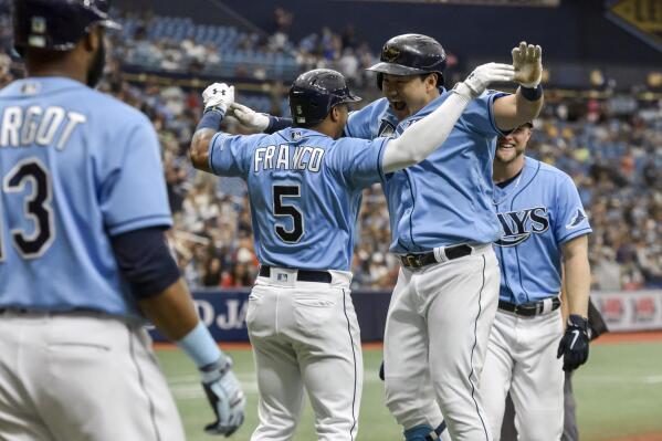 Tampa Bay Ray' Manuel Margot (13), Wander Franco (5) and Austin Meadows, right, celebrate with Ji-Man Choi after Choi's three-run home run off Los Angeles Angels reliever Mike Mayers during the sixth inning of a baseball game Sunday, June 27, 2021, in St. Petersburg, Fla. (AP Photo/Steve Nesius)