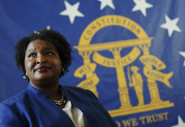 HOLD FOR STORY BY JEFF AMY EMBARGOED UNTIL 06:00 AM EST Aug. 9, 2020**Democratic candidate for Georgia Governor Stacey Abrams poses for a portrait in front of the State Seal of Georgia Monday, Aug. 8, 2022, in Decatur, Ga. (AP Photo/John Bazemore)