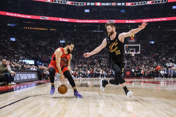 Toronto Raptors guard Fred VanVleet (23) is defended by Cleveland Cavaliers forward Dean Wade (32) during the first half of an NBA basketball game Wednesday, Oct. 19, 2022, in Toronto. (Christopher Katsarov/The Canadian Press via AP)