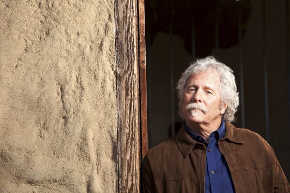 Chris Hillman, a founding member of the Byrds and Flying Burrito Brothers, and one of the architects of country-rock and folk-rock, poses at  the Ortega Adobe in Ventura, Calif., on Dec. 3, 2020. Hillman published a memoir, "Time Between: My Life as a Byrd, Burrito Brother and Beyond," revealing what it was like rising to rock 'n' fame in the '60s and the triumphs and tragedy that he witnessed. (Lori Stoll via AP)