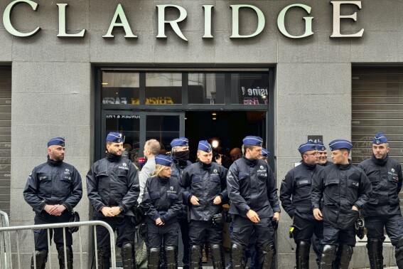 Police stand guard outside the front entrance of the event venue as the National Conservatism conference takes place in Brussels, Tuesday, April 16, 2024. (AP Photo/Sylvain Plazy)