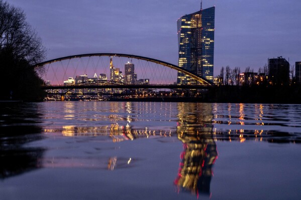 FILE - The European Central Bank is reflected in the river Main in Frankfurt, Germany, March 21, 2024. Europe’s economy perked up slightly at the start of the year, recording 0.3% growth in the January-March quarter as the inflation burden on consumers eased and the stagnating German economy, the continent’s biggest, started to show modest signs of life. (AP Photo/Michael Probst, File)