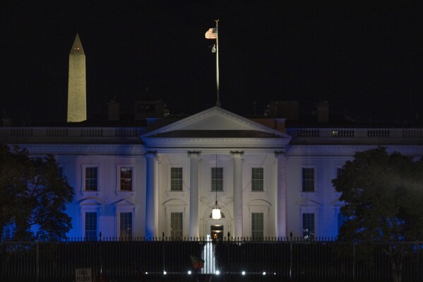 The White House is lit in blue and white, the colors of the Israeli flag, to underscore U.S. solidarity with Israel, Monday, Oct. 9, 2023, in Washington. (AP Photo/Jon Elswick)