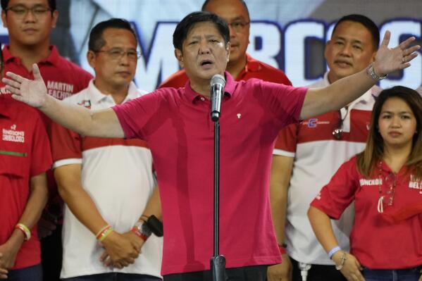 Ferdinand "Bongbong" Marcos Jr. gestures as he greets the crowd during a campaign rally in Quezon City, Philippines on April 13, 2022. Marcos Jr., son of the late dictator and his running mate Sara, who is the daughter of the outgoing President Rodrigo Duterte, are leading pre-election surveys despite his family's history. (AP Photo/Aaron Favila)