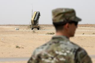 FILE - A member of the U.S. Air Force stands near a Patriot missile battery at the Prince Sultan air base in al-Kharj, central Saudi Arabia, on Feb. 20, 2020. The U.S. has transferred a significant number of Patriot antimissile interceptors to Saudi Arabia in recent weeks as the Biden administration looks to ease what has been a point of tension in the increasingly complicated U.S.-Saudi relationship.   (Andrew Caballero-Reynolds/Pool via AP, File)