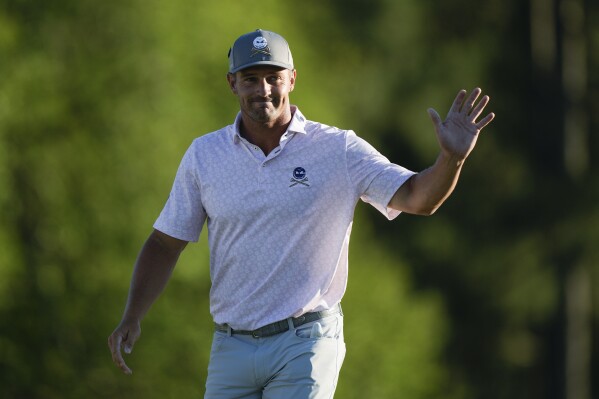 Bryson DeChambeau celebrates after a birdie on the 18th hole during third round at the Masters golf tournament at Augusta National Golf Club Saturday, April 13, 2024, in Augusta, Ga. (AP Photo/Charlie Riedel)