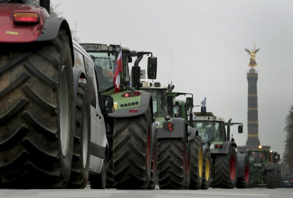 Farmers have parked their tractors on a road close to the Victory Column in Berlin, Germany, Tuesday, Nov. 26, 2019. Some thousands farmers are expected in the German capital for a protest rally against the German and European agriculture policy. (AP Photo/Michael Sohn)
