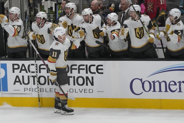 Vegas Golden Knights left wing Mason Morelli (11) is congratulated by teammates after scoring against the San Jose Sharks during the first period of an NHL hockey game in San Jose, Calif., Monday, Feb. 19, 2024. (AP Photo/Jeff Chiu)