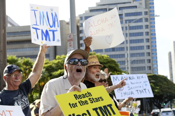 Supporters of the Thirty Meter Telescope, gather for a rally outside the Hawaii State Capitol in Honolulu on Thursday, July 25, 2019. Supporters said the giant telescope planned for Hawaii's tallest mountain will enhance humanity's knowledge of the universe and bring quality, high-paying jobs, as protesters blocked construction for a second week. (AP Photo/Audrey McAvoy)