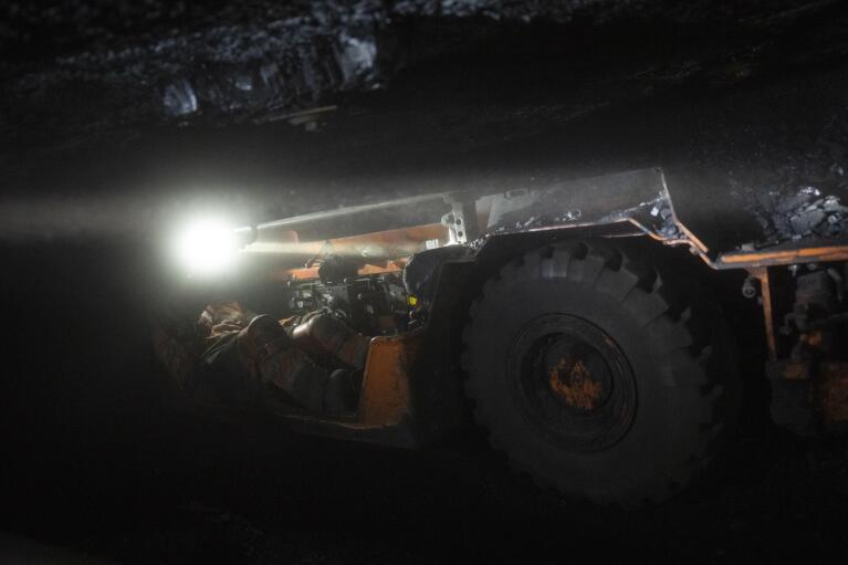 A coal miner operates machinery at the bottom of the Gruve 7 coal mine in Adventdalen, Norway, Monday, Jan. 9, 2023. Gruve 7, the last Norwegian mine in one of the fastest warming places on earth, was scheduled to shut down this year and only got a reprieve through 2025 because of the energy crisis driven by the war in Ukraine. (AP Photo/Daniel Cole)