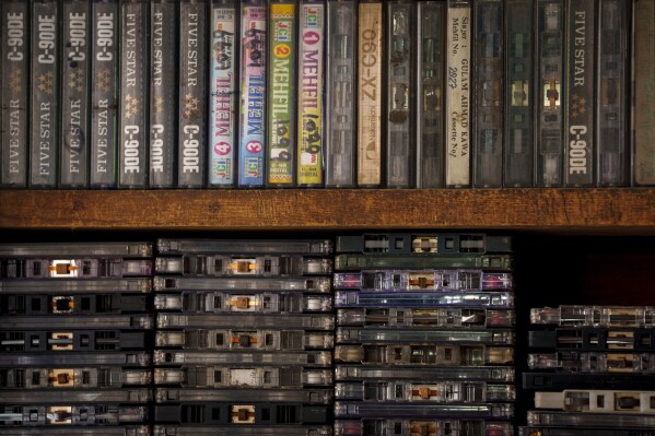 Old and damaged cassette tapes are stacked on a shelf at self-taught mechanic Mohammad Ashraf Matoo’s workshop in Srinagar, Indian controlled Kashmir, Tuesday, Feb. 11, 2025. (AP Photo/Dar Yasin)