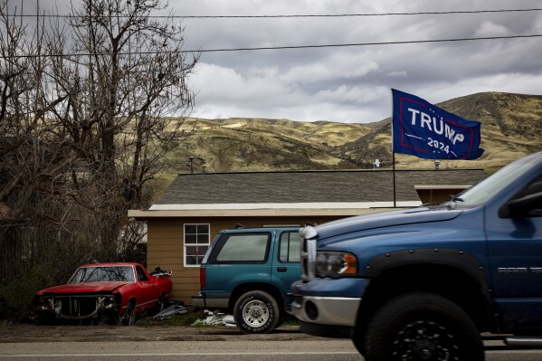 A flag supporting former President Donald Trump for president in 2024 flies in the front yard of a house in Horseshoe Bend, Idaho,Monday April 24, 2023. Americans are segregating by their politics at a rapid clip, helping fuel the greatest divide between the states in modern history. (AP Photo/Kyle Green)