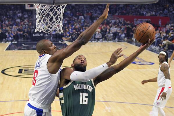 Milwaukee Bucks guard Jeff Dowtin, right, shoots as Los Angeles Clippers center Serge Ibaka defends during the first half of an NBA basketball game Sunday, Feb. 6, 2022, in Los Angeles. (AP Photo/Mark J. Terrill)