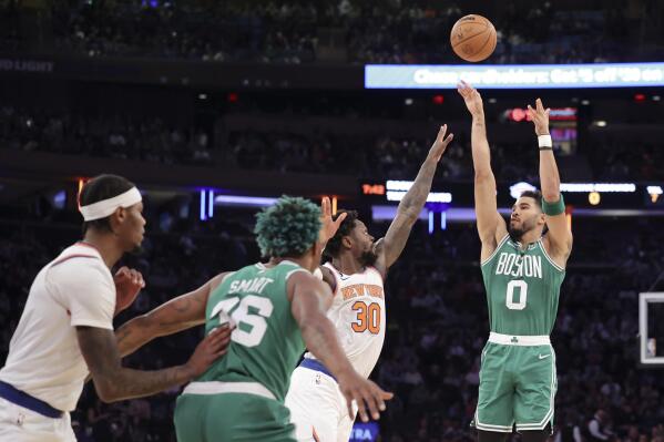 Boston Celtics forward Jayson Tatum (0) shoots as New York Knicks forward Julius Randle (30) defends and Boston Celtics guard Marcus Smart (36) watches during the first half of an NBA basketball game Saturday, Nov. 5, 2022, at Madison Square Garden in New York. (AP Photo/Jessie Alcheh)