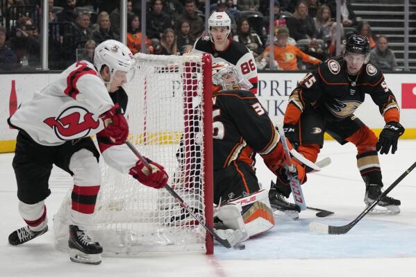 New Jersey Devils left wing Jesper Bratt, left, scores against Anaheim Ducks goaltender John Gibson (36) during the second period of an NHL hockey game in Anaheim, Calif., Friday, Jan. 13, 2023. (AP Photo/Ashley Landis)