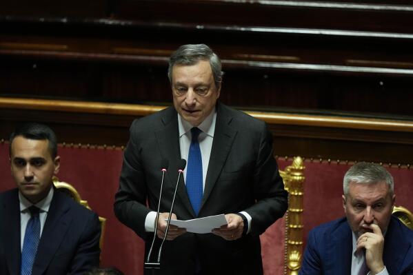 Italian Premier Mario Draghi, center, flanked by Foreign Minister Luigi Di Maio, left, and Defense Minister Lorenzo Guerini, delivers his speech at the Senate in Rome, Wednesday, July 20, 2022. Draghi was deciding Wednesday whether to confirm his resignation or reconsider appeals to rebuild his parliamentary majority after the populist 5-Star Movement triggered a crisis in the government by withholding its support. (AP Photo/Andrew Medichini)