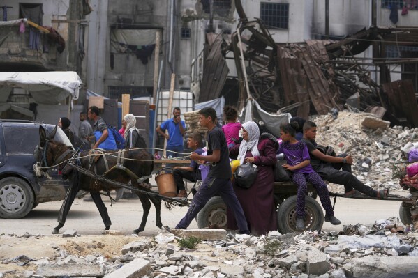 Displaced Palestinians fleeing Beit Lahia amid ongoing Israeli military operations in the Gaza Strip arrive in Jabalia, northern Gaza, on Sunday, May 18, 2025. (AP Photo/Jehad Alshrafi)