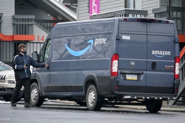 FILE - An Amazon Prime driver makes a delivery in Pittsburgh on Monday, Jan. 23, 2023. The Wisconsin Supreme Court dismissed a lawsuit Tuesday, March 26, 2024, brought by Amazon’s logistics subsidiary, which had sought to overturn a lower court's ruling that it had misclassified delivery drivers as independent contractors instead of employees. (AP Photo/Gene J. Puskar, file)