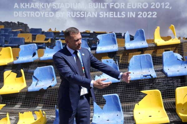 Andriy Shevchenko, Ukrainian football legend and UAF President, presents an installation ahead of the Group E match between Romania and Ukraine at the Euro 2024 soccer tournament in Munich, Germany, Monday, June 17, 2024. A poignant installation has been unveiled ahead of Ukraine’s first match at the European Championship. A destroyed stand from Kharkiv’s Sonyachny stadium that was built for Euro 2012 has been displayed in a square in Munich ahead of the team’s opener against Romania. (AP Photo/Ariel Schalit)