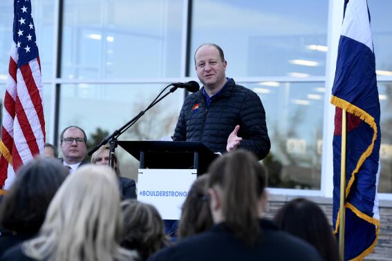 Colorado Gov. Jared Polis speaks during the ceremony to officially reopen the Table Mesa store on, Wednesday, Feb. 9, 2022 in Boulder, Colo. Nearly a year after 10 people were shot and killed at a supermarket in Colorado, the redesigned store in the college town of Boulder is back open. (Helen H. Richardson/The Denver Post via AP)