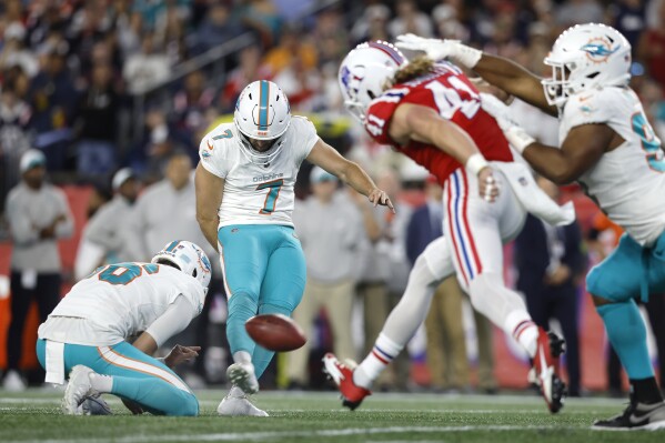 Miami Dolphins place kicker Jason Sanders (7) hits a field goal while pressured by New England Patriots safety Brenden Schooler (41) during the first half of an NFL football game, Sunday, Sept. 17, 2023, in Foxborough, Mass. (AP Photo/Michael Dwyer)