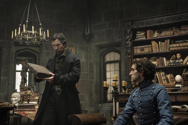 This image released by Netflix shows Christian Bale as Augustus Landor, left, and Harry Melling as Edgar Allan Poe in a scene from "The Pale Blue Eye." (Scott Garfield/Netflix via AP)