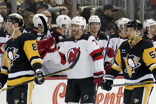 New Jersey Devils teammates congratulate defenseman Dougie Hamilton (7) after he scored against the Pittsburgh Penguins during the second period of an NHL hockey game in Pittsburgh, Saturday, Feb. 18, 2023. (AP Photo/Matt Freed)