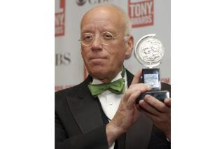 FILE - Eugene Lee poses with his Tony Award for Best Scenic Design for "Wicked" at the Tony Awards in New York on June 6, 2004. Lee, the six-time Emmy Award-winning production designer for “Saturday Night Live” and who won three Tony Awards for his Broadway sets, died Tuesday in Providence, R.I. He was 83. (AP Photo/Richard Drew, File)
