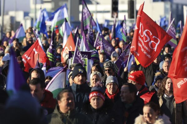 Public sector workers walk from the picket line at the Royal Victoria Hospital to a rally at Belfast City Hall, in Belfast, Thursday, Jan. 18, 2024, as an estimated 150,000 workers take part in walkouts over pay across Northern Ireland. (Liam McBurney/PA via AP)